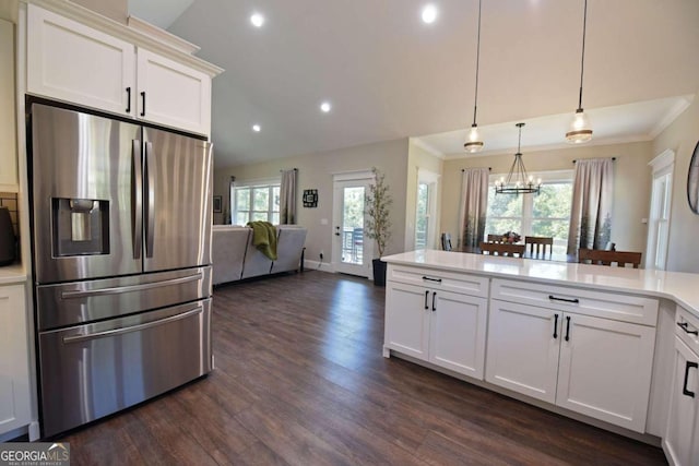 kitchen featuring dark wood-style floors, light countertops, stainless steel fridge, and white cabinetry