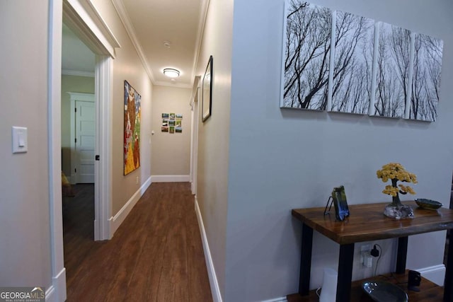 hall featuring ornamental molding, dark wood finished floors, and baseboards