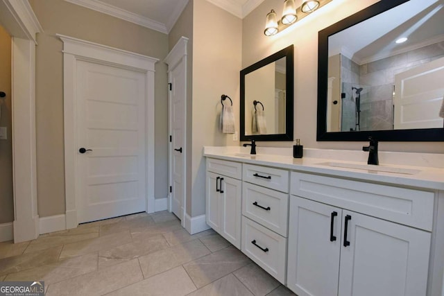 full bath featuring a sink, baseboards, ornamental molding, a shower stall, and double vanity