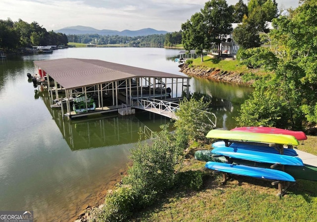 dock area featuring boat lift and a water and mountain view