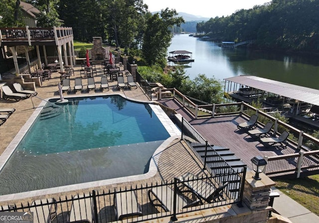 community pool with a patio, stairway, and a deck with water view