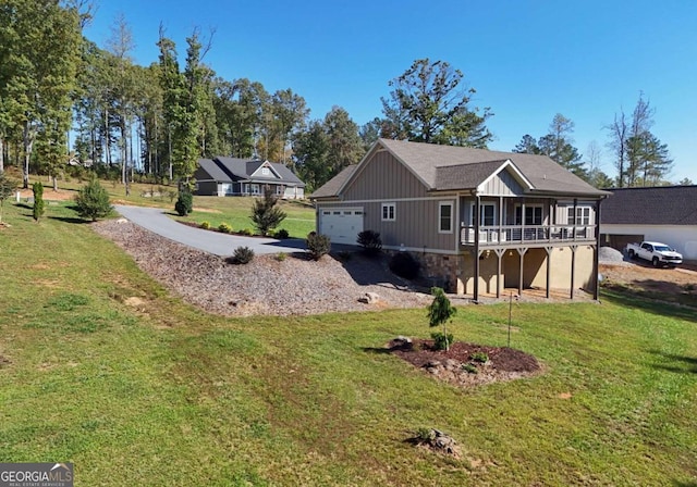 view of home's exterior with stone siding, a lawn, and driveway