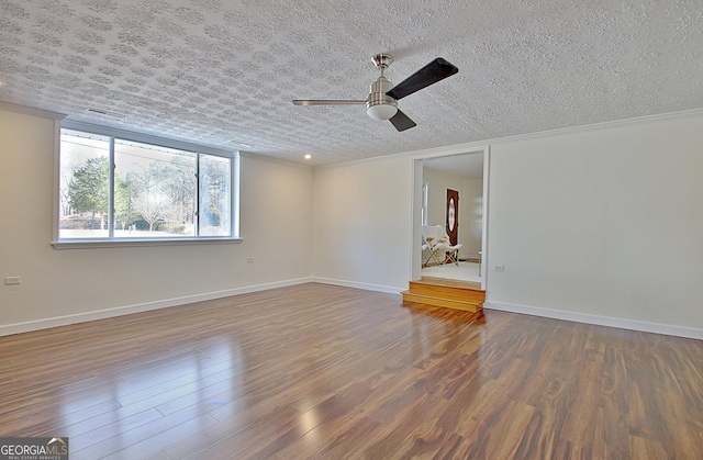 interior space featuring crown molding, ceiling fan, a textured ceiling, wood finished floors, and baseboards