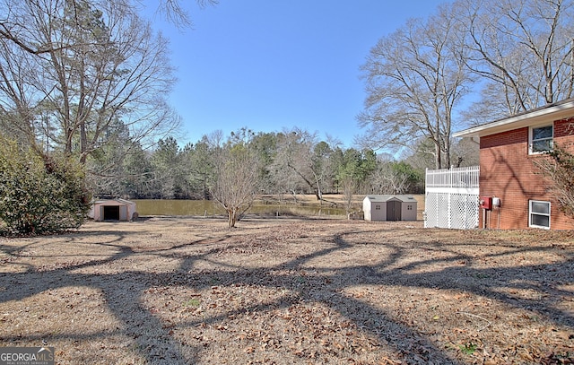 view of yard featuring a storage shed and an outdoor structure