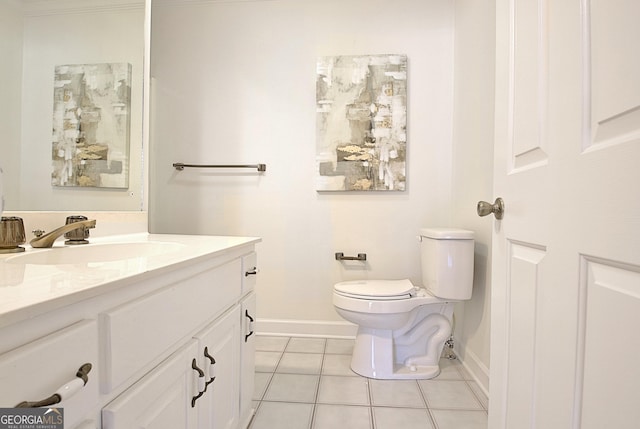 bathroom featuring baseboards, vanity, toilet, and tile patterned floors