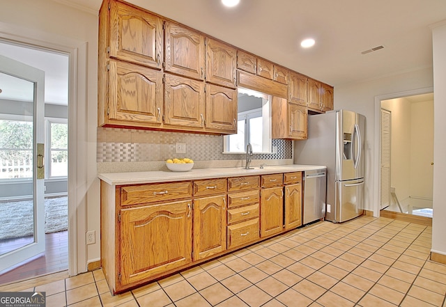 kitchen featuring light tile patterned floors, visible vents, appliances with stainless steel finishes, light countertops, and backsplash