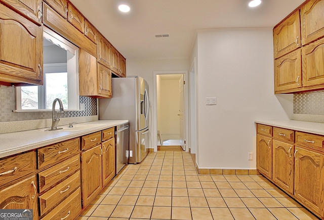 kitchen with tasteful backsplash, dishwasher, and a sink