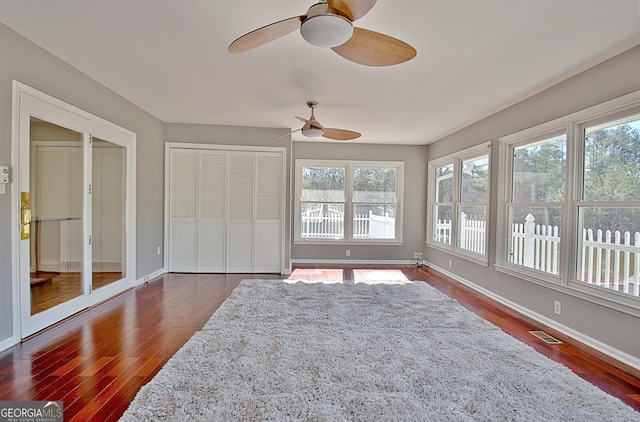 sunroom / solarium featuring ceiling fan and visible vents