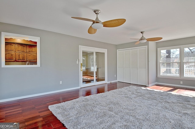 bedroom with a ceiling fan, a closet, baseboards, and dark wood-type flooring