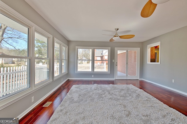 sunroom with a ceiling fan and visible vents