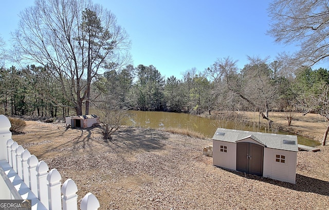 view of yard with a shed, an outdoor structure, and a water view