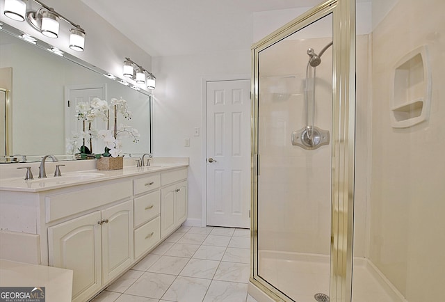 full bathroom with marble finish floor, a sink, and a shower stall