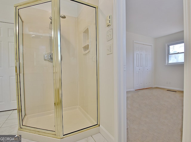 bathroom featuring a shower stall, visible vents, and baseboards