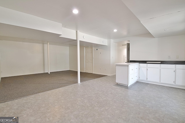 finished below grade area featuring tile patterned floors, baseboards, and recessed lighting