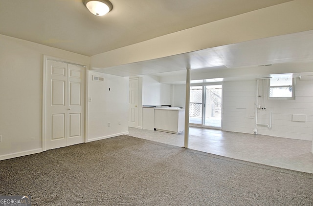 interior space with visible vents, baseboards, and speckled floor