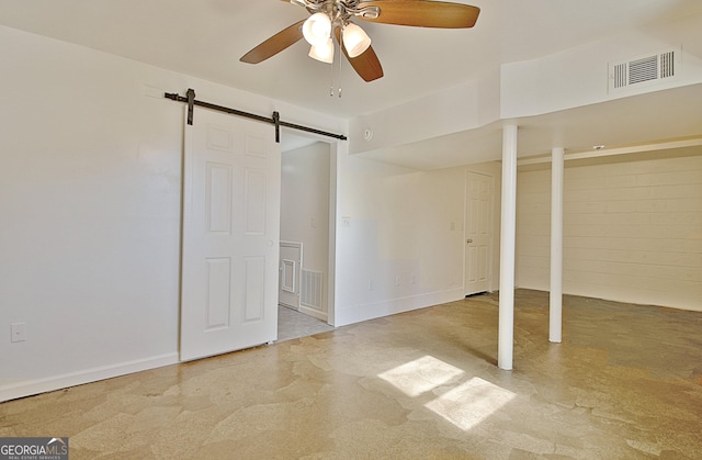 unfurnished bedroom with ceiling fan, a barn door, concrete floors, and visible vents