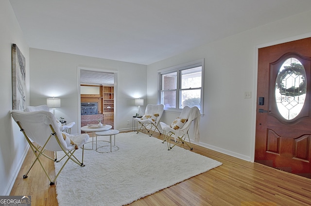 interior space featuring a fireplace, baseboards, and wood finished floors