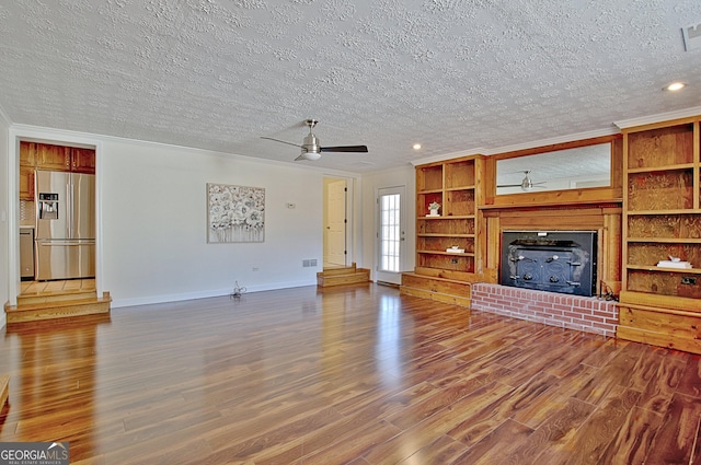 unfurnished living room with ornamental molding, wood finished floors, and a ceiling fan