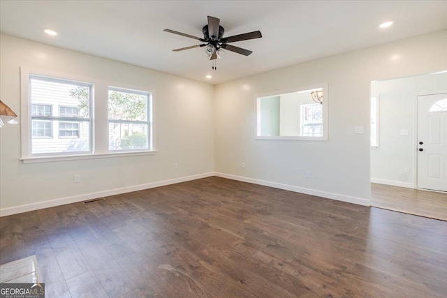 interior space featuring dark wood-style flooring, recessed lighting, visible vents, a ceiling fan, and baseboards