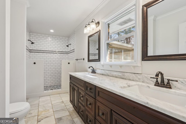 bathroom with walk in shower, a sink, toilet, and crown molding