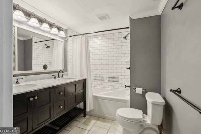 bathroom featuring ornamental molding, shower / bath combination with curtain, a sink, and toilet