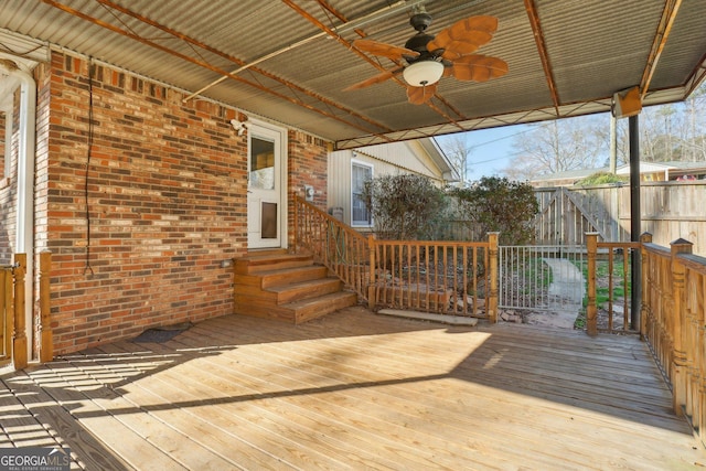 wooden terrace featuring entry steps, ceiling fan, and fence