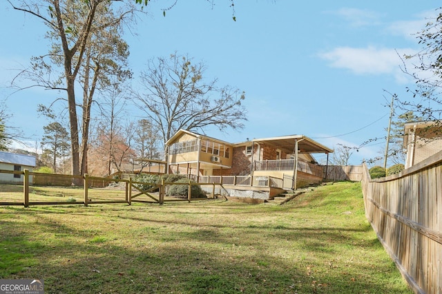 back of property with stairs, a lawn, and a fenced backyard