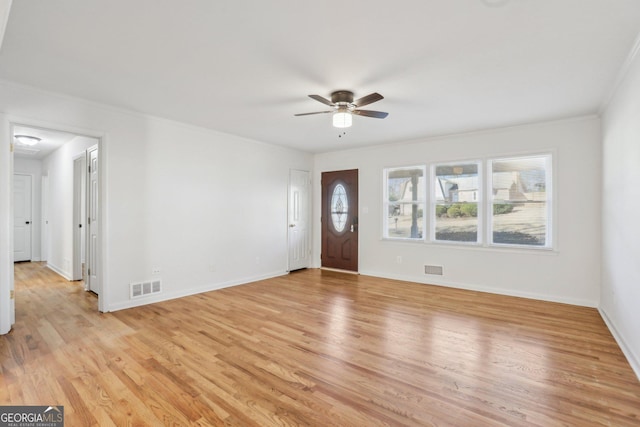 entryway with light wood-style flooring, a ceiling fan, visible vents, and baseboards