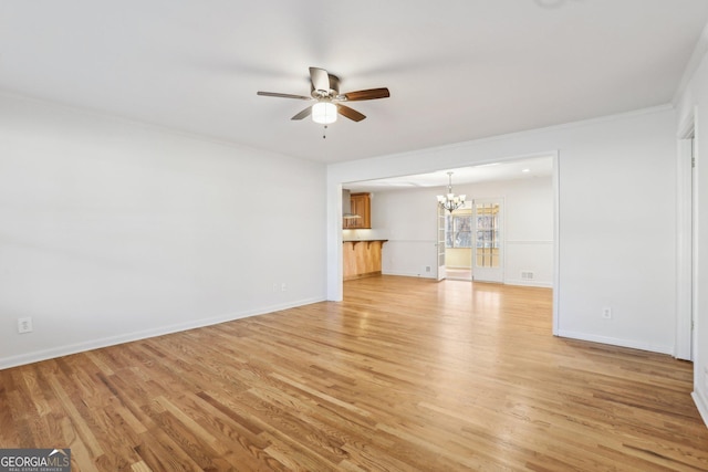 unfurnished living room with light wood-style flooring, baseboards, and ceiling fan with notable chandelier