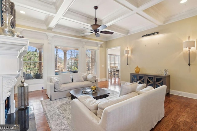 living area with a lit fireplace, beamed ceiling, and coffered ceiling