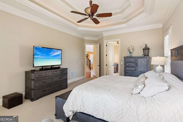 carpeted bedroom with a ceiling fan, visible vents, baseboards, ornamental molding, and a raised ceiling