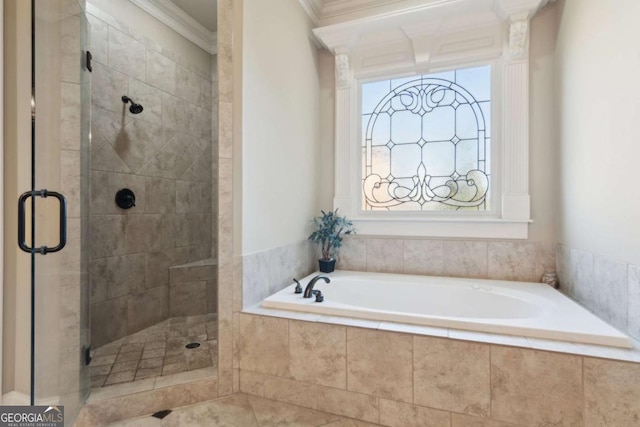 bathroom with a healthy amount of sunlight, a stall shower, a garden tub, and crown molding