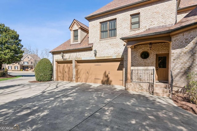 view of front of property with concrete driveway and brick siding