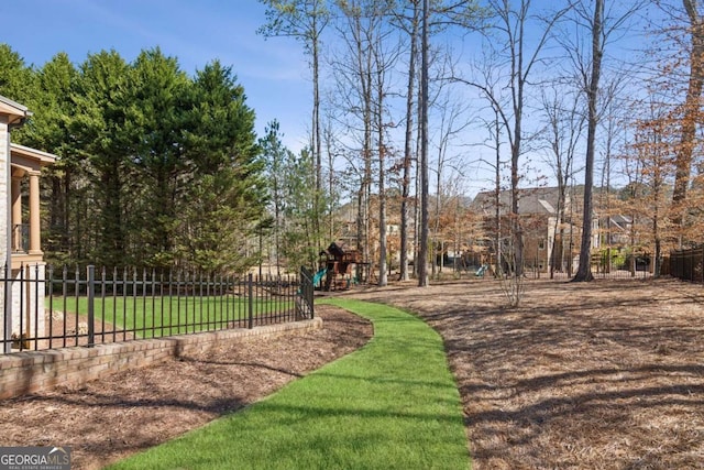 view of home's community featuring fence and playground community