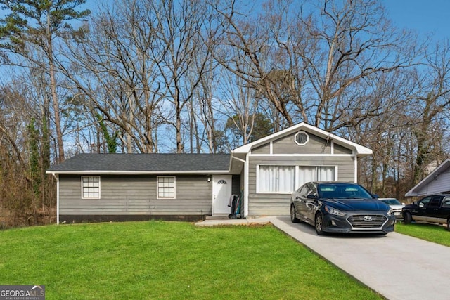 ranch-style home with driveway, a garage, and a front lawn