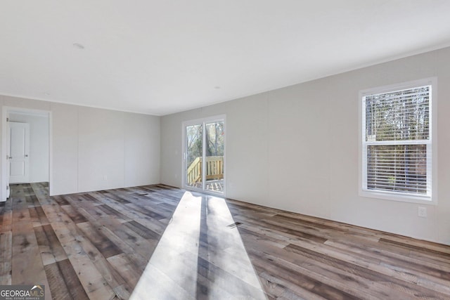 unfurnished room with wood finished floors