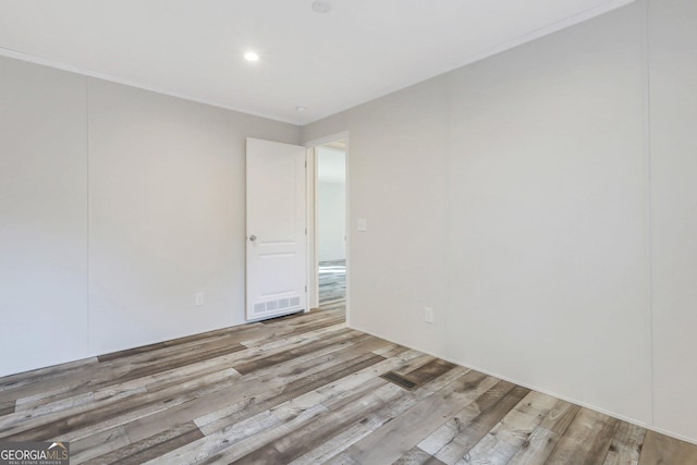 spare room with wood finished floors and recessed lighting