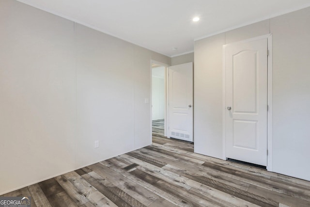 unfurnished bedroom with recessed lighting and wood finished floors