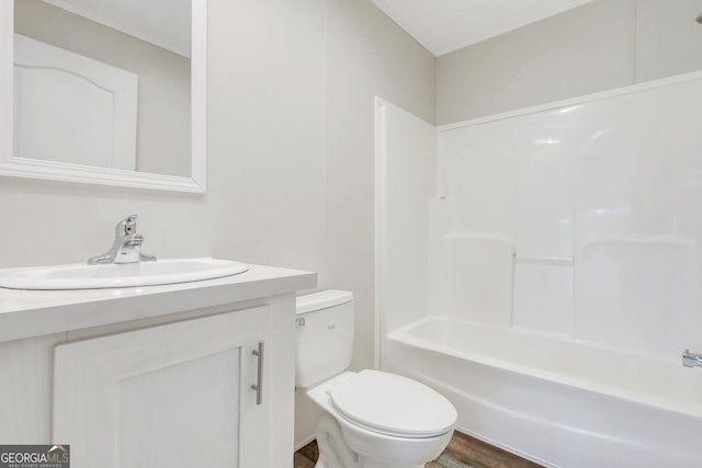 bathroom featuring wood finished floors, tub / shower combination, vanity, and toilet