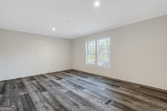 unfurnished room with recessed lighting, visible vents, and wood finished floors