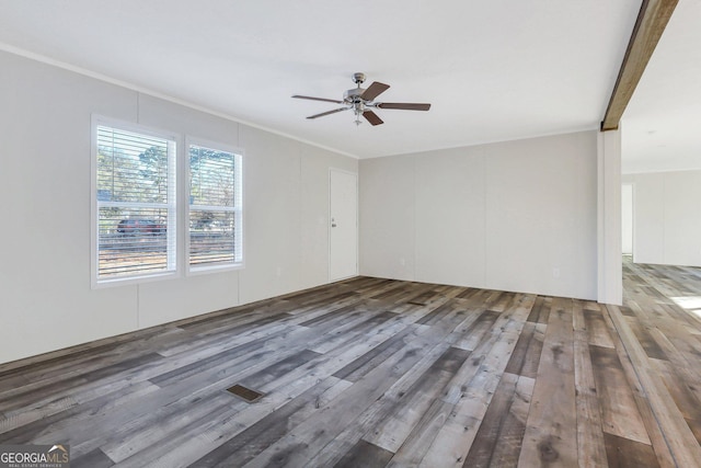 unfurnished room with ornamental molding, ceiling fan, and wood finished floors