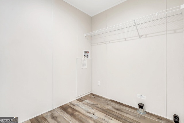 laundry room featuring washer hookup, laundry area, and wood finished floors