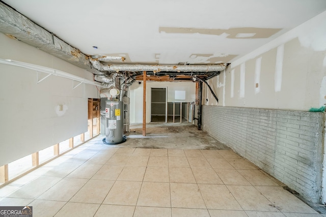 3524 Exeter Ct, Snellville, GA 30039 - unfinished below grade area with brick wall, tile patterned flooring, and electric water heater