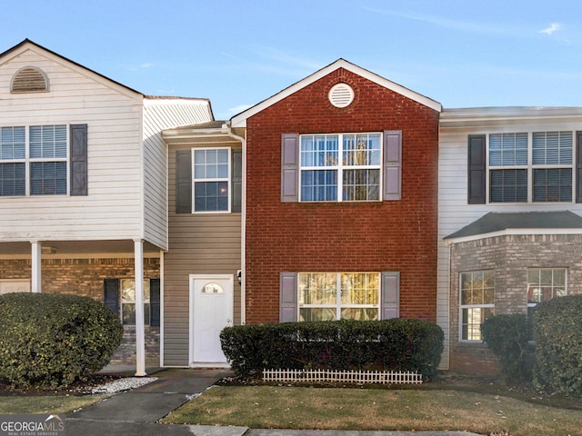 townhome / multi-family property with brick siding