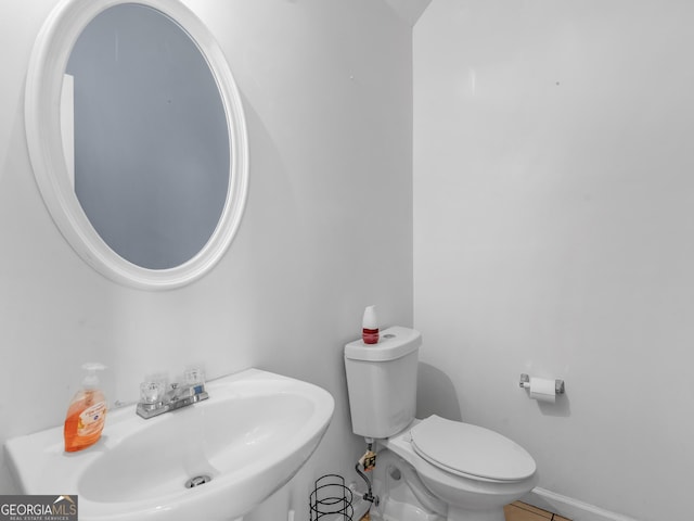 bathroom featuring toilet and a sink