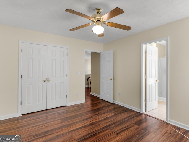 unfurnished bedroom with baseboards, ceiling fan, wood finished floors, a textured ceiling, and a closet