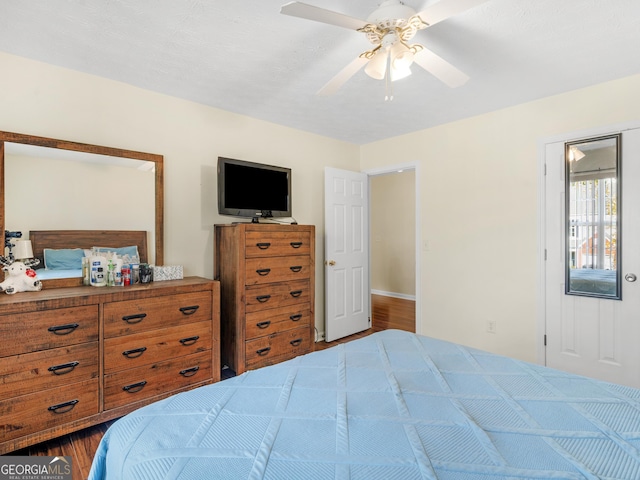 bedroom featuring dark wood-style flooring and a ceiling fan