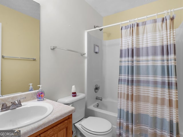 bathroom featuring shower / bath combination with curtain, vanity, toilet, and a textured ceiling