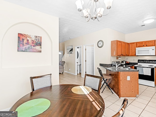 dining space featuring a textured ceiling, light tile patterned flooring, visible vents, and a notable chandelier