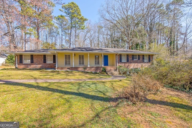 single story home featuring a front yard and brick siding